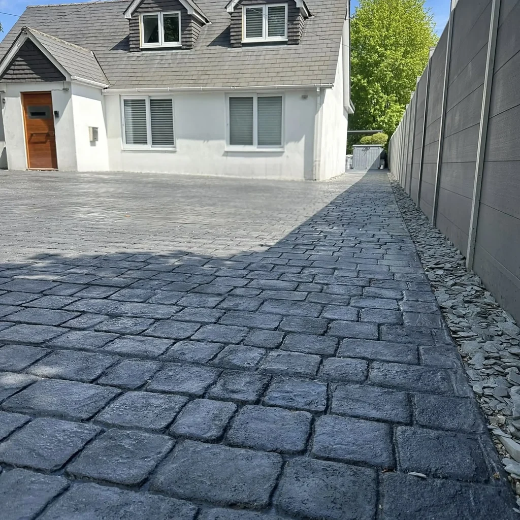 grey-cobble-stamped-concrete-driveway-dormer-house