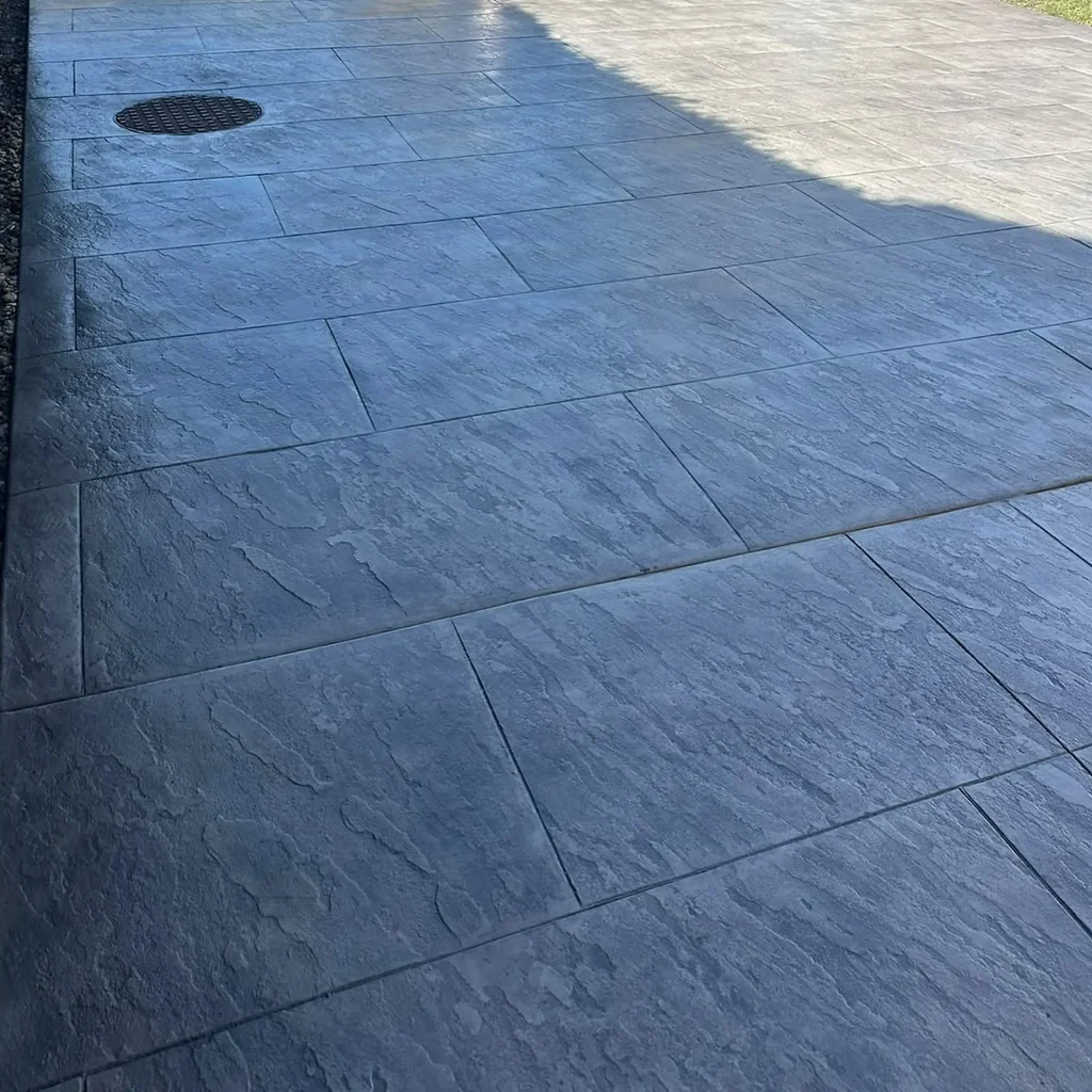 grey-stamped-concrete-driveway-manhole
